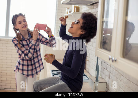 Joyful kids playing together with food in kitchen Stock Photo