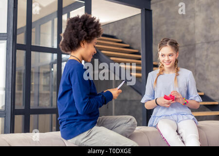 Attentive international boy playing cards with opponent Stock Photo