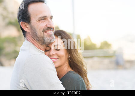 Romantic couple smiling,  cuddling and hugging on a sunny day Stock Photo