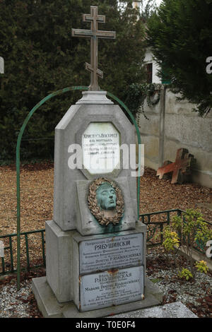 Grave of the Russian physicist Dimitri Riabouchinsky (1882-1962) and his relatives at the Russian Cemetery in Sainte-Geneviève-des-Bois (Cimetière russe de Sainte-Geneviève-des-Bois) near Paris, France. The death mask of his daughter Maria Riabouchinskaya who was a painter and died in 1936 at age 26 in a car accident is placed on the tombstone. Stock Photo