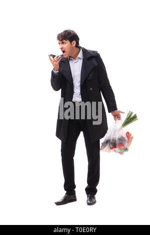 Young handsome man with vegatables in shopping concept Stock Photo