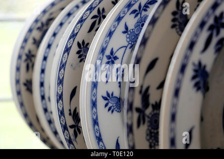 old blue and white dinner plates in kitchen rack