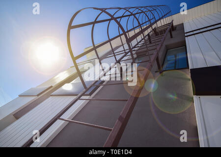 Metal ladder on the wall of the house Stock Photo