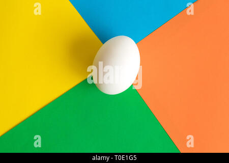 White egg on colorful background minimal easter creative concept. Stock Photo