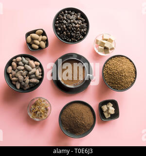 Concept of coffee, cacao beans and sugar on pink background. Top view. Stock Photo