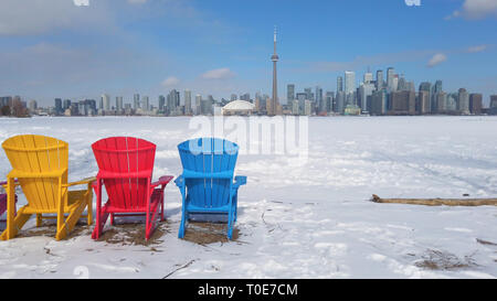 View of Toronto city skyline seen form Toronto Islands with colourful chairs