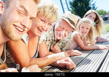 Extended family summer vacation on the lake with happy grandparents and children Stock Photo