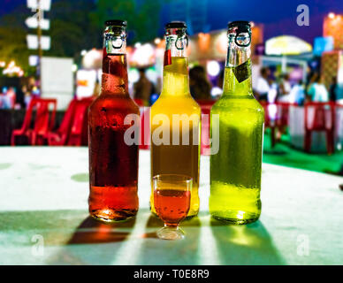 Bottles of different colored wine lined up adjacent to each other to celebrate the success, at a wine tasting festival, depicting lavish lifestyle. Stock Photo