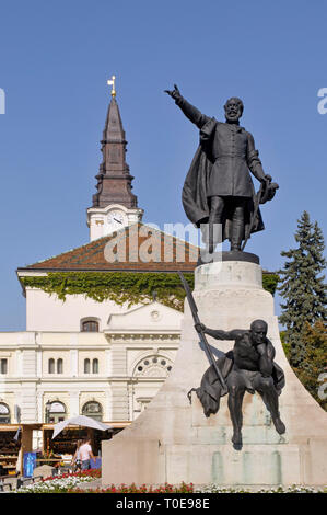 the Kossuth Lajos statue at Kossuth Lajos ter square and Calvinist church in background, Kecskemet Hungary Stock Photo