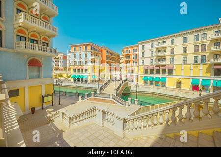 Large staircase leading to a Venetian bridge on canals of picturesque Qanat Quartier icon of Doha, Qatar in a sunny day with blue sky. Venice at the Stock Photo