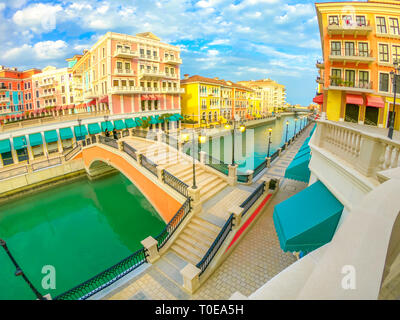 Wide angle view of panoramic bridge in Venice at Qanat Quartier in the Pearl, Persian Gulf, Middle East at sunset. Aerial view picturesque and Stock Photo
