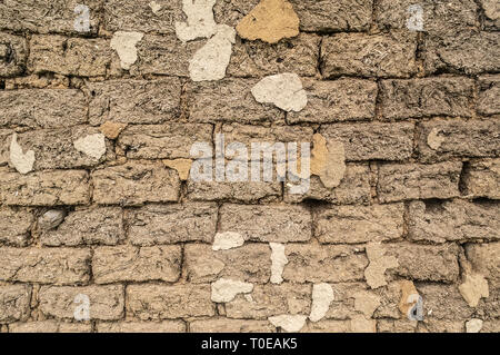 Texture of wall made of clay bricks with straw Stock Photo