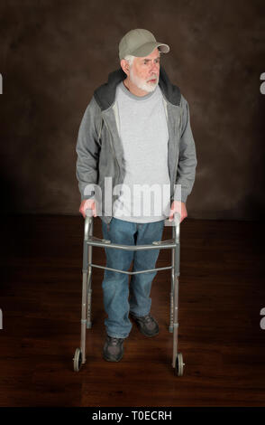 Vertical shot of an Older Man With Walker On Brown Looking Off Camera. Stock Photo