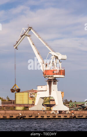 Working cranes unload cargo in a seaport in Sweden Stock Photo