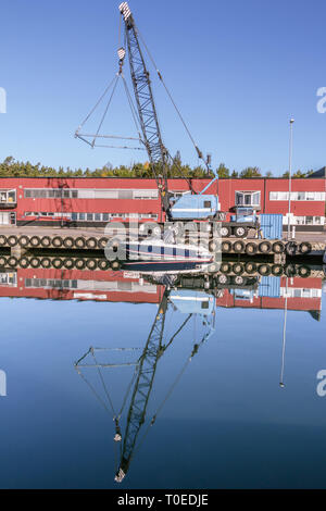 Blue crane for liftin boats out of the water Stock Photo