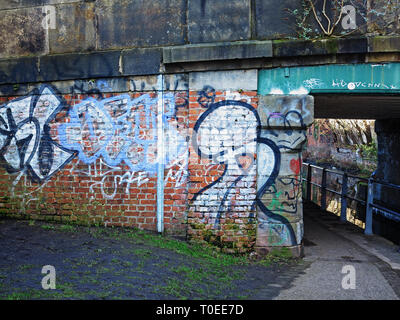 Graffiti on an old canal bridge on the Ashton Canal, Manchester Stock Photo