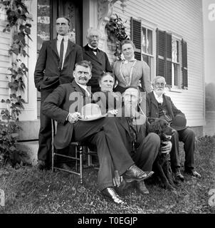 The family elders gather outside of the house for a group portrait, ca. 1915. Stock Photo