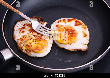 Fried eggs in a pan. Natural lighting. Close up. Stock Photo