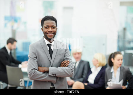Happy smiling successful African American businessman in a suit in a ...