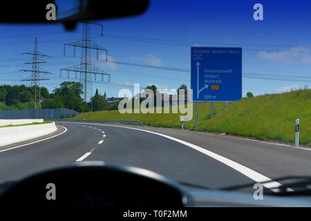 German motorway sign with inscription in German Driving direction to the cities - Velbert, Heiligenhaus, Wuelfrath and Hetterscheidt Stock Photo