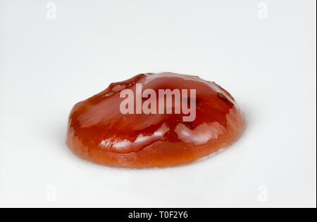 Macro image of a blob of strawberry jam against a white background Stock Photo