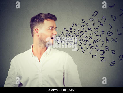 Man talking with alphabet letters coming out of his mouth. Communication, information, concept Stock Photo