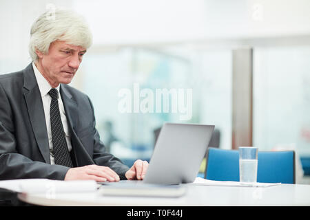 Senior Businessman Using Laptop Stock Photo