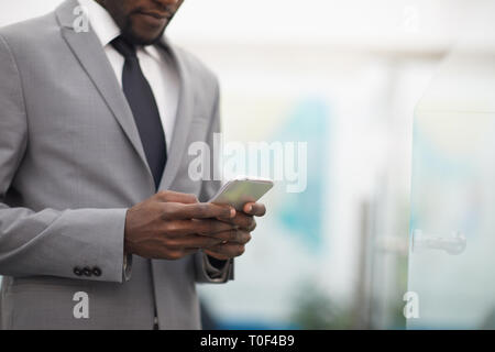 African Businessman Using Smartphone Closeup Stock Photo