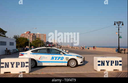 New York, USA - July 02, 2018: NYPD vehicle parked on the Coney Island beach boardwalk at sunset. Stock Photo