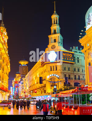 SHANGHAI, CHINA - DECEMBER 28, 2016: Illuminated cityscape with people walking at shopping street of downtown Stock Photo