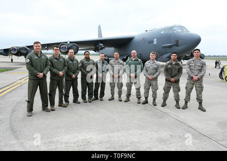 RAF Fairford, Gloucestershire, UK. 19th March 2019. Flight crew from the USAF 2nd Bomb Wing stand in front of a B-52H Stratofortress bomber as RAF Fairford welcomes a Bomber Task Force deployment of six Boeing B-52H Stratofortress aircraft to RAF Fairford from the 2nd Bomb Wing in Louisiana, USA - the largest deployment of B-52s to the UK since Operation Iraqi Freedom in 2003. The aircraft will perform training sorties over The Baltic, Central Europe and the Eastern Mediterranean. Credit: Steven May/Alamy Live News Stock Photo