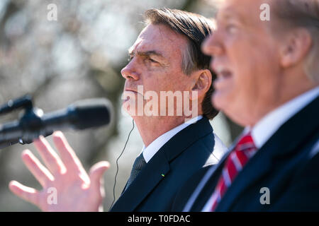 US President Donald J. Trump (R) and Brazilian President Jair Bolsonaro (L) speak at a press conference in the Rose Garden of the White House in Washington, DC, USA, 19 March 2019. Bolsonaro, a right-wing nationalist, earned the nickname the 'Trump of the Tropics.' Credit: Jim LoScalzo / Pool via CNP /MediaPunch Stock Photo