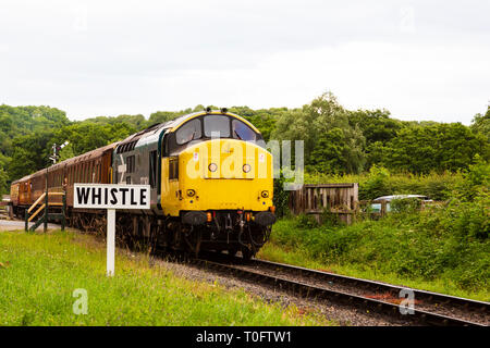 Restored British Rail Class 37 diesel engine 37264 of the North Yorkshire Moors Railway passing whistle sign outside Pickering, North Yorkshirem Engla Stock Photo