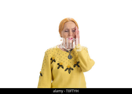 Senior lady with headache isolated. Upset woman with closed eyes. Symptom of increased intracranial pressure. Stock Photo