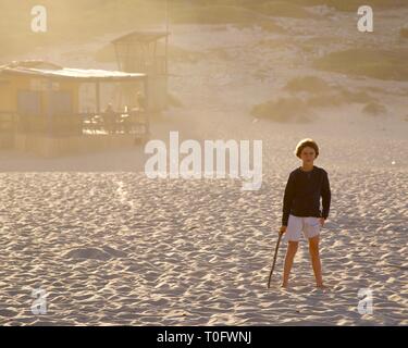 Young boy in front of rustic Beach Shack at Cala Torta, Mallorca at sunset Stock Photo