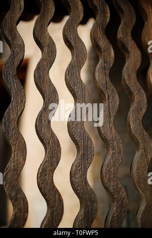 Detail of the beautiful curved wavy wooden slats of a church gate Stock Photo