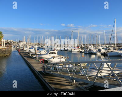 Variety of yachts and boats moored up by a jetty at the Marina Rubicon in Playa Blanca Stock Photo