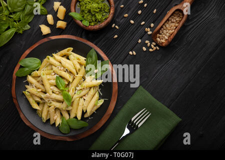 Pasta with pesto on black Stock Photo