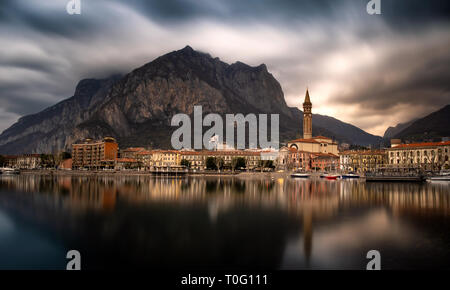 Panorama of Lecco city reflected on the lake in a amazing cloudy day, Lombardy, Italy Stock Photo