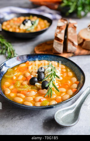 Fasolatha – delicious Greek white bean soup sprinkled with feta cheese Stock Photo