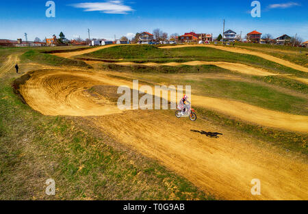 Aerial view of racing motocross bikes in racetrack. Outdoor motor sport from drone view. - Image Stock Photo