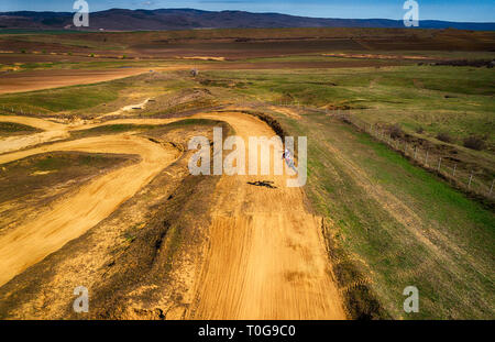 Aerial view of racing motocross bikes in racetrack. Outdoor motor sport from drone view. - Image Stock Photo