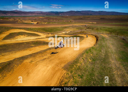 Aerial view of racing motocross bikes in racetrack. Outdoor motor sport from drone view. - Image Stock Photo