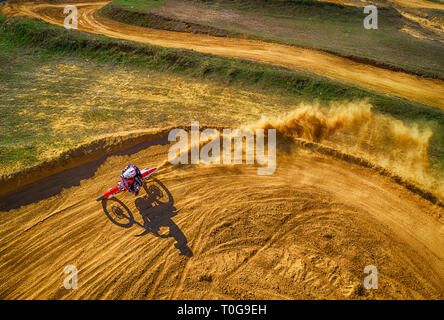 Aerial view of racing motocross bikes in racetrack. Outdoor motor sport from drone view. - Image Stock Photo