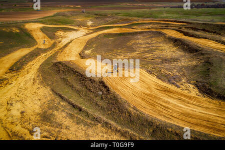 Aerial view of racing motocross bikes in racetrack. Outdoor motor sport from drone view. - Image Stock Photo