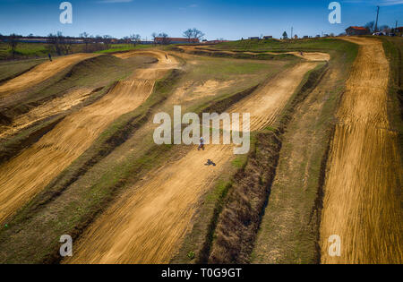 Aerial view of racing motocross bikes in racetrack. Outdoor motor sport from drone view. - Image Stock Photo