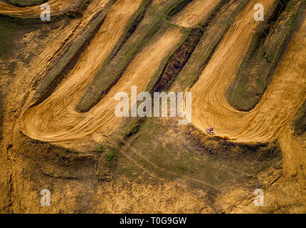 Aerial view of racing motocross bikes in racetrack. Outdoor motor sport from drone view. - Image Stock Photo