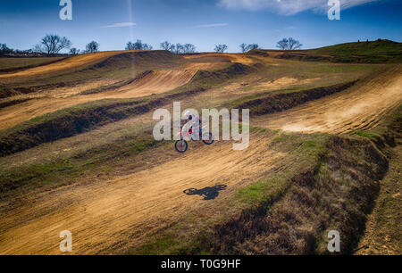 Aerial view of racing motocross bikes in racetrack. Outdoor motor sport from drone view. - Image Stock Photo