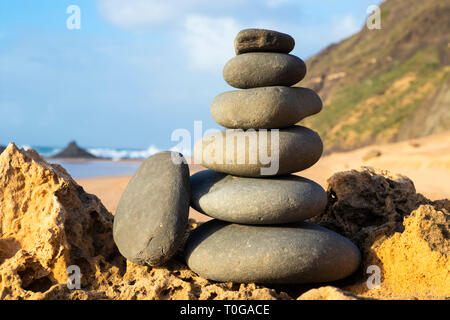stack of pebbles Rock balancing stone stacks on beach cairn Algarve Portugal EU Europe Stock Photo