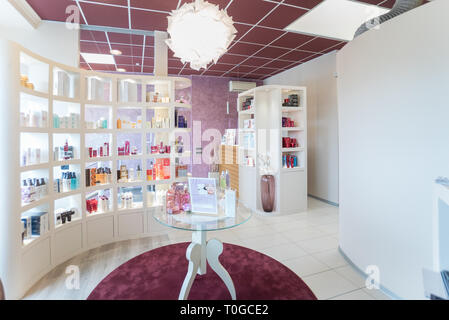 Verona, Italy - April 4, 2016: Cosmetics displayed on the shelves of a modern beauty salon. Stock Photo